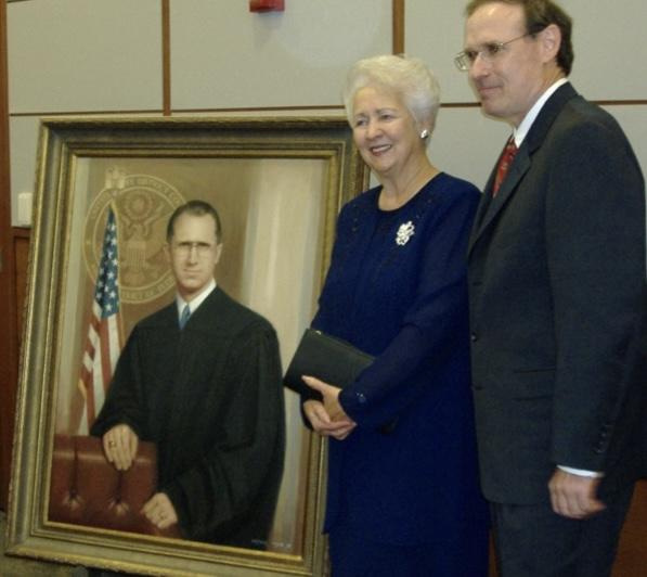 Mrs. Penny Nimmons and Harold Davis beside Judge Ralph Nimmons’s portrait